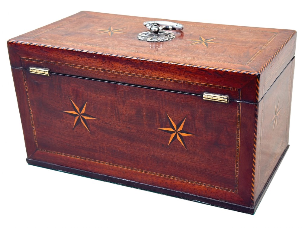 A rectangular 18th-century mahogany tea caddy featuring inlaid wooden star motifs on the front panel and a brass ring handle on top. View XI