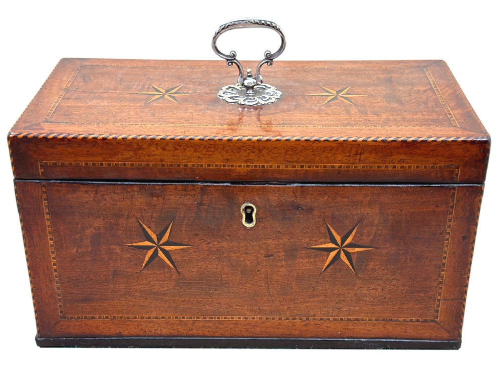 A rectangular 18th-century mahogany tea caddy featuring inlaid wooden star motifs on the front panel and a brass ring handle on top. View XII