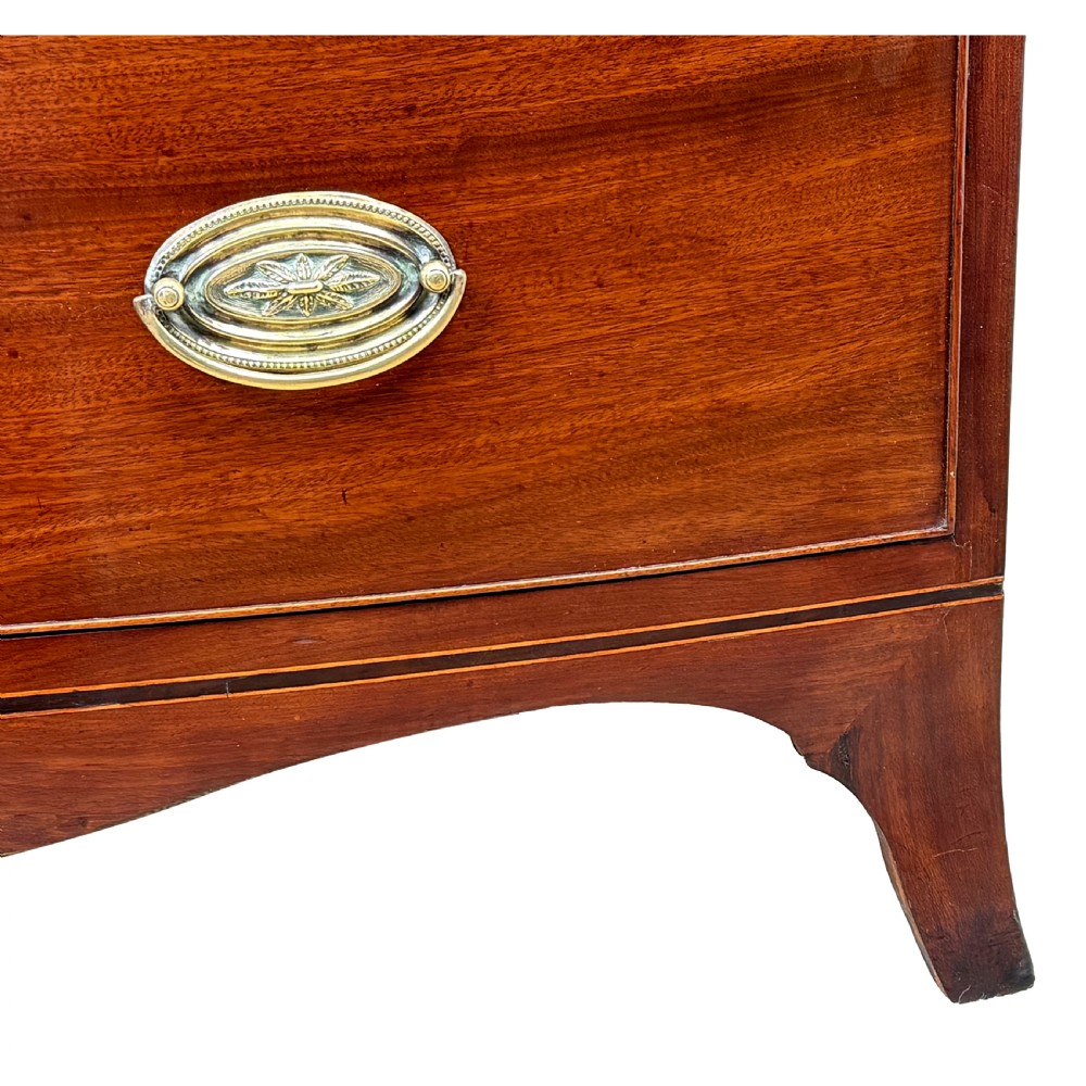 An 18th century George III mahogany bowfront chest of drawers with three graduated drawers and splayed bracket feet. View V