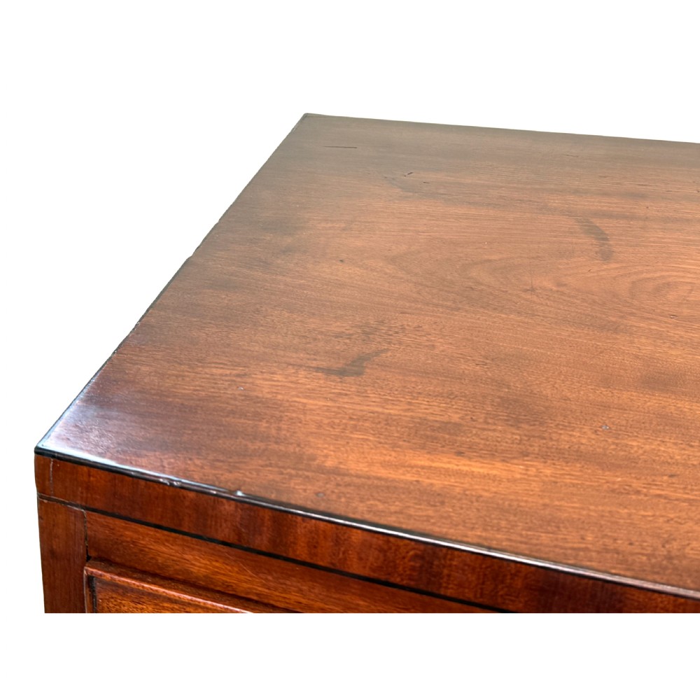 An 18th century George III mahogany bowfront chest of drawers with three graduated drawers and splayed bracket feet. View VII