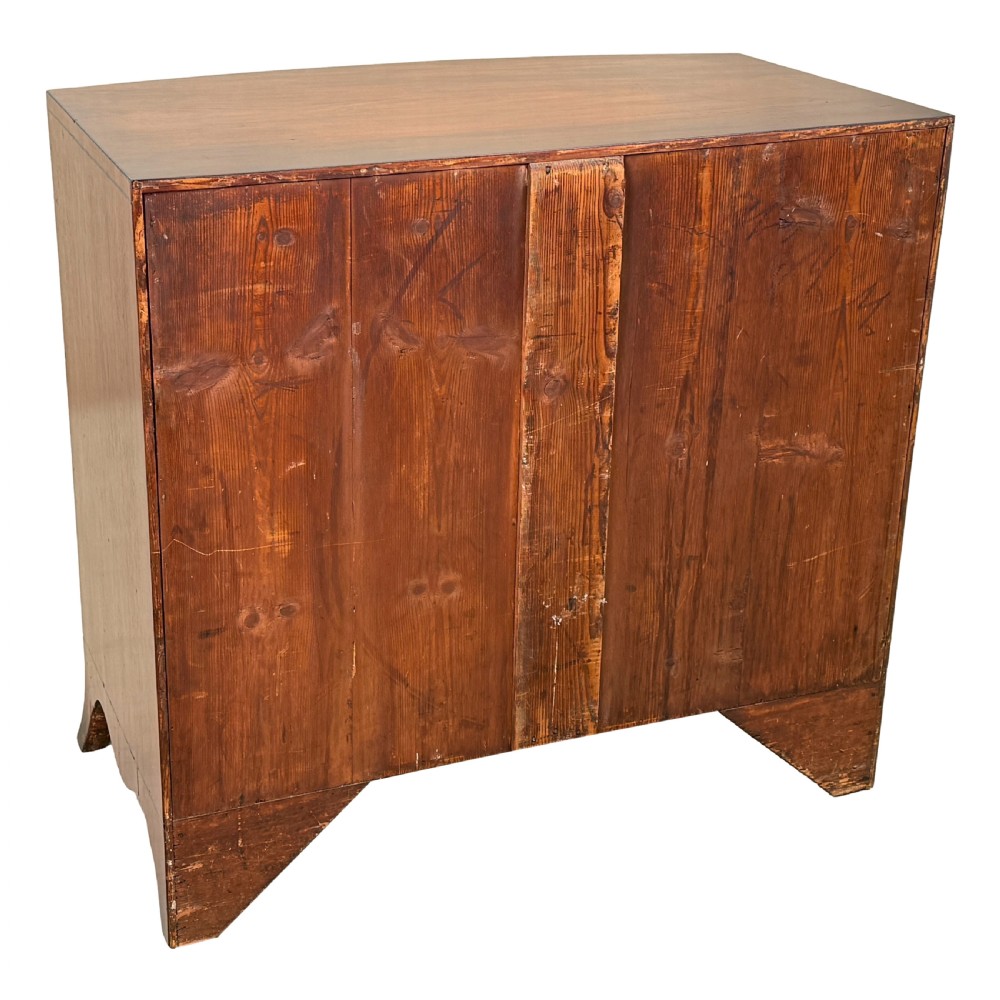 An 18th century George III mahogany bowfront chest of drawers with three graduated drawers and splayed bracket feet. View IX