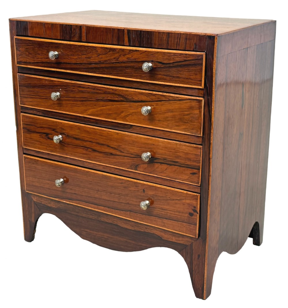 A Georgian rosewood miniature chest of four graduated drawers featuring stringing inlay and small round knob pulls. View IV