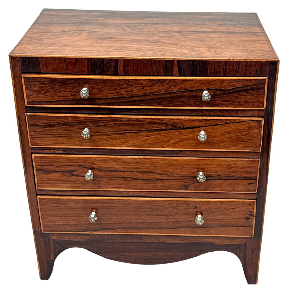 A Georgian rosewood miniature chest of four graduated drawers featuring stringing inlay and small round knob pulls. View XI