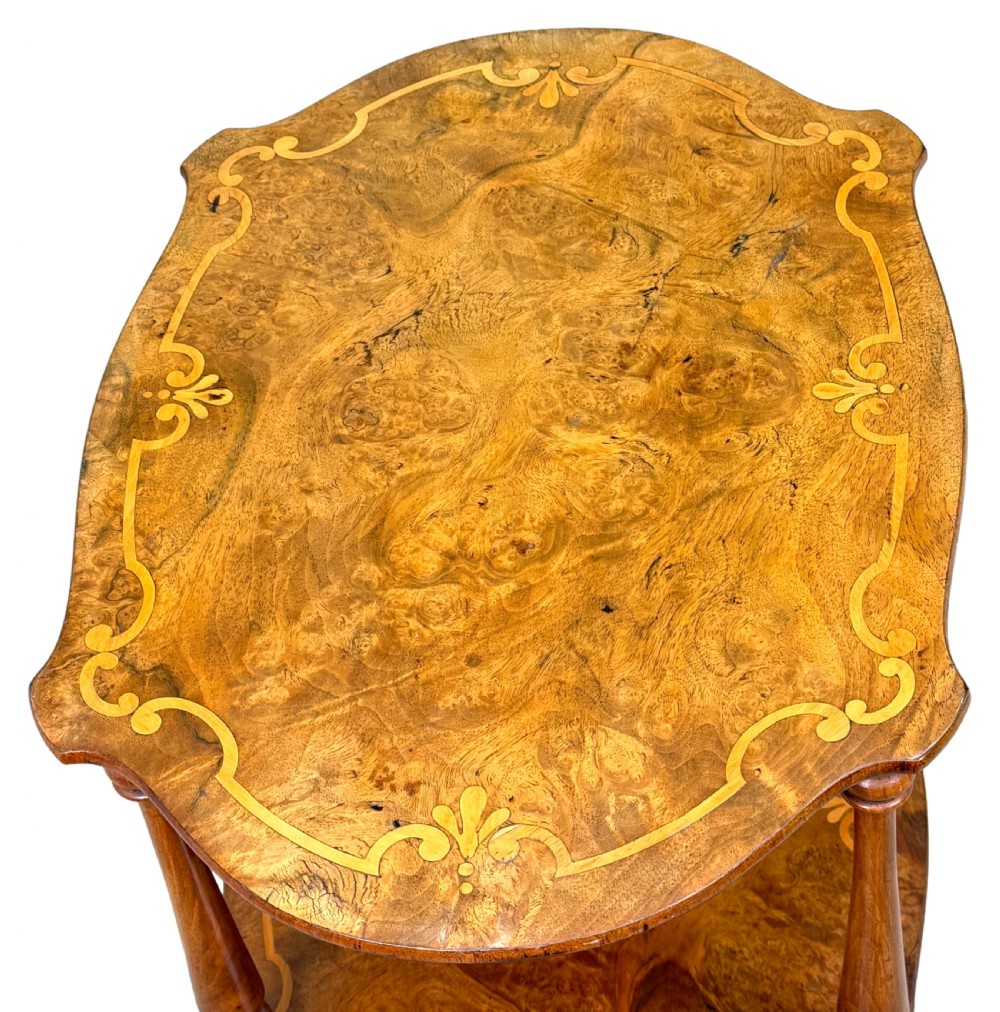 A 19th-century three-tiered burr walnut etagere featuring floral marquetry inlays, slender turned supports, and brass castors. View III