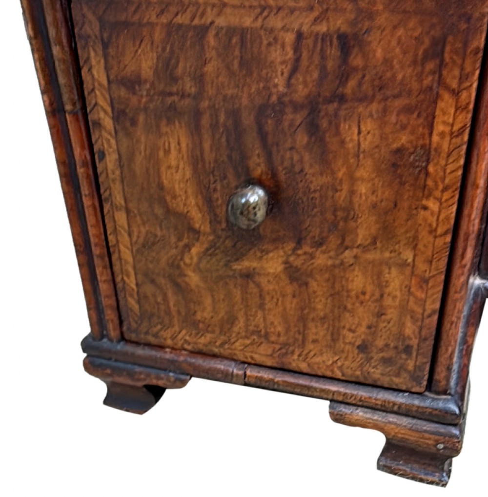 An early 18th-century Georgian walnut dressing table mirror featuring a shaped carved cresting, turned supports, and a base with miniature drawers and a central arch. View XIII