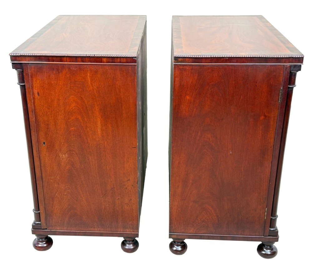 A pair of matching Regency mahogany side cupboards featuring flame veneer panel doors, flanking columns, and turned ball feet. View III