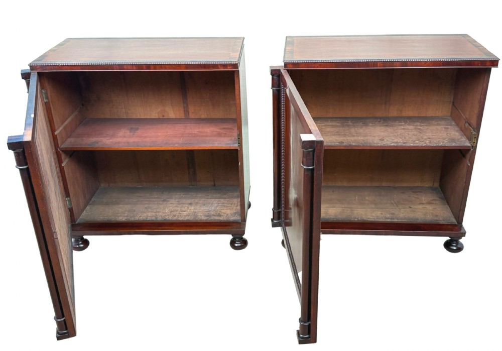 A pair of matching Regency mahogany side cupboards featuring flame veneer panel doors, flanking columns, and turned ball feet. View VI