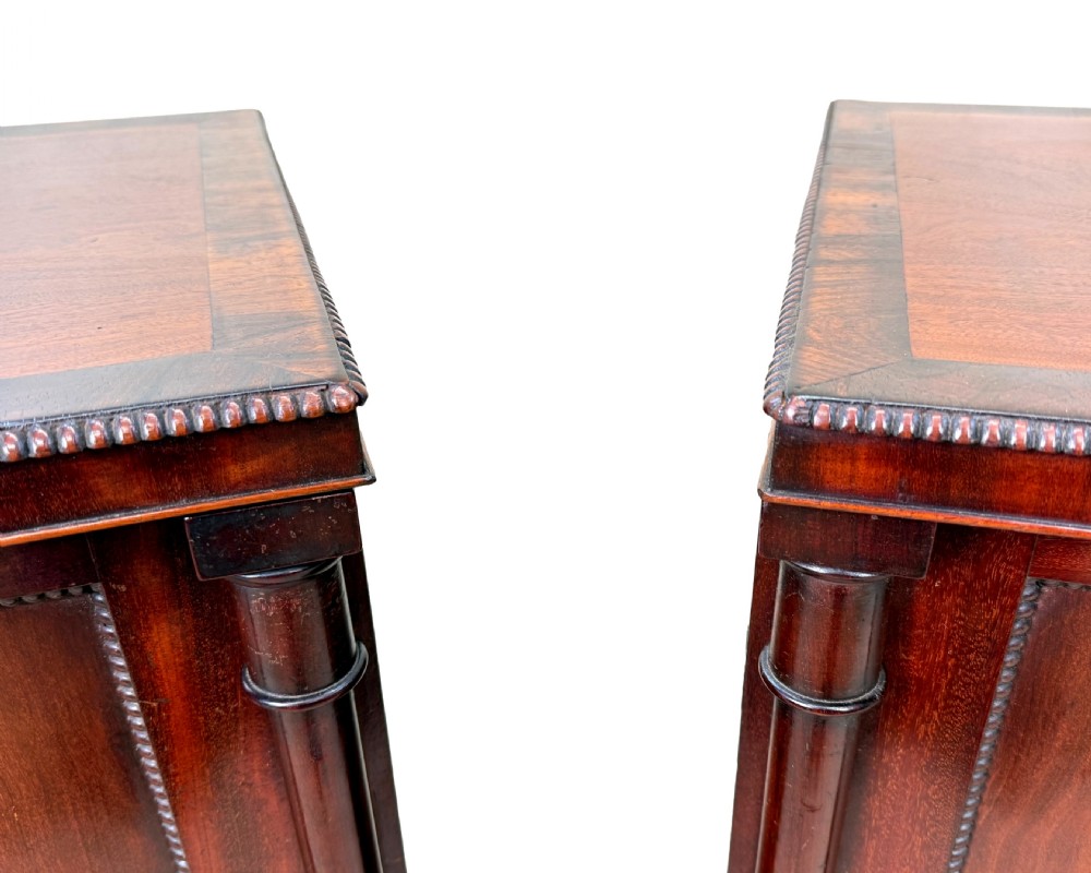 A pair of matching Regency mahogany side cupboards featuring flame veneer panel doors, flanking columns, and turned ball feet. View VII