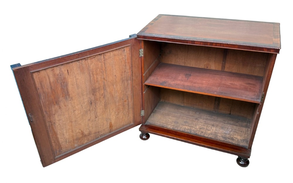 A pair of matching Regency mahogany side cupboards featuring flame veneer panel doors, flanking columns, and turned ball feet. View X