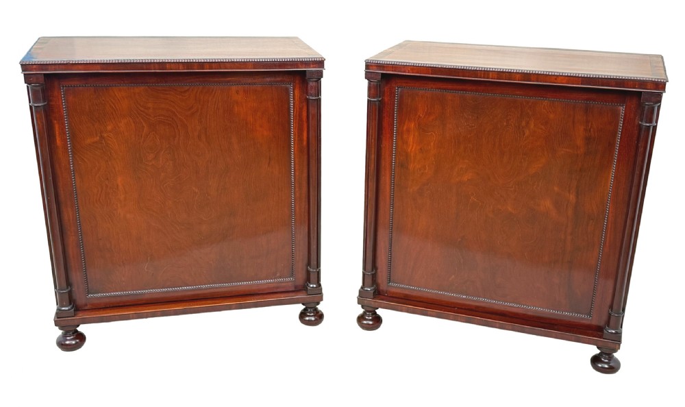 A pair of matching Regency mahogany side cupboards featuring flame veneer panel doors, flanking columns, and turned ball feet. View XI