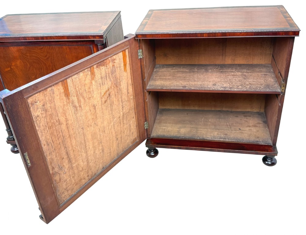 A pair of matching Regency mahogany side cupboards featuring flame veneer panel doors, flanking columns, and turned ball feet. View XII