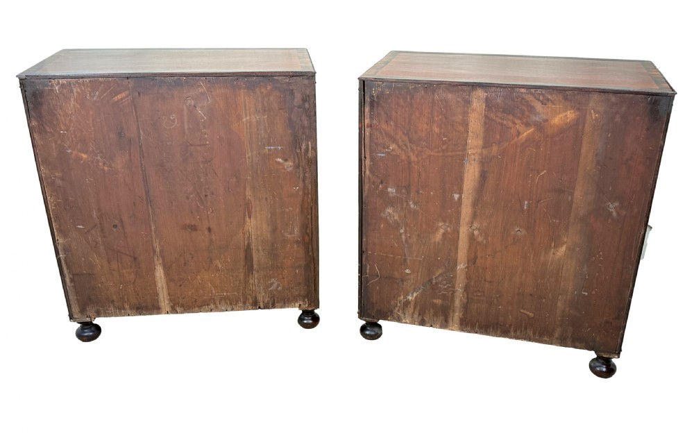 A pair of matching Regency mahogany side cupboards featuring flame veneer panel doors, flanking columns, and turned ball feet. View XIII