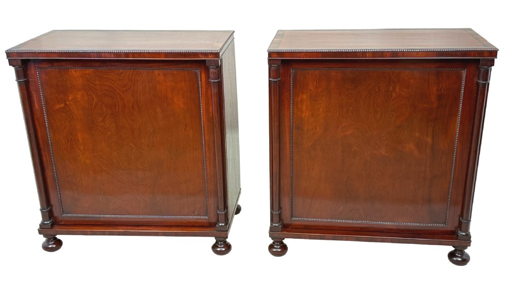 A pair of matching Regency mahogany side cupboards featuring flame veneer panel doors, flanking columns, and turned ball feet. View XIV