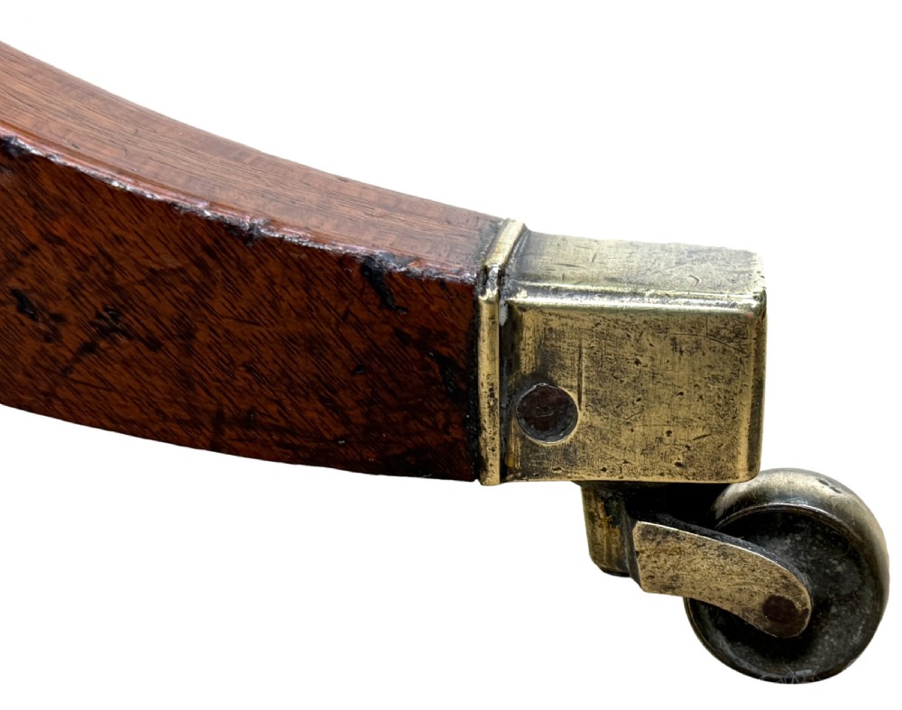 A Georgian mahogany baby Pembroke table with two drop leaves, double drawers with inlay, a turned central pedestal, and sabre tripod legs on brass castors. View XII