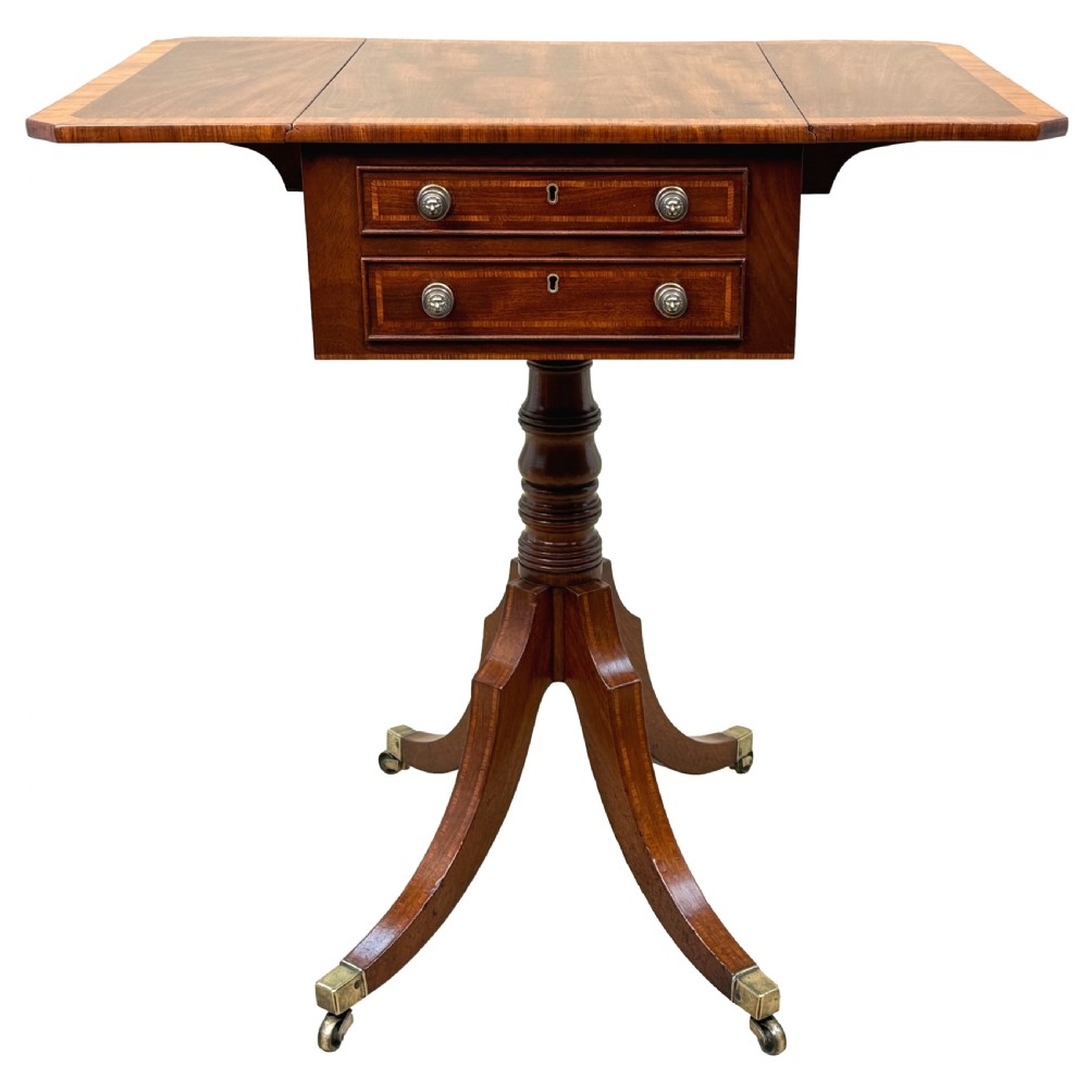 A Georgian mahogany baby Pembroke table with two drop leaves, double drawers with inlay, a turned central pedestal, and sabre tripod legs on brass castors. View XIII