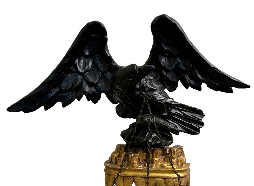 A Regency giltwood tripartite overmantel mirror featuring ball moulding details, ebonised inner slips, and an ebonised eagle crest surmount. View IV