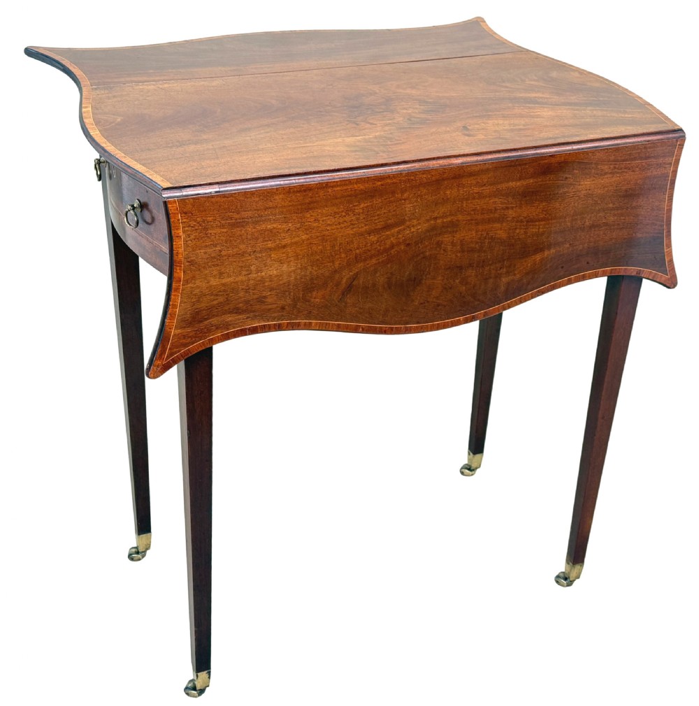 An 18th-century Hepplewhite mahogany Pembroke table with extended shaped drop leaves, a single drawer, and tapered legs on brass castors. View II