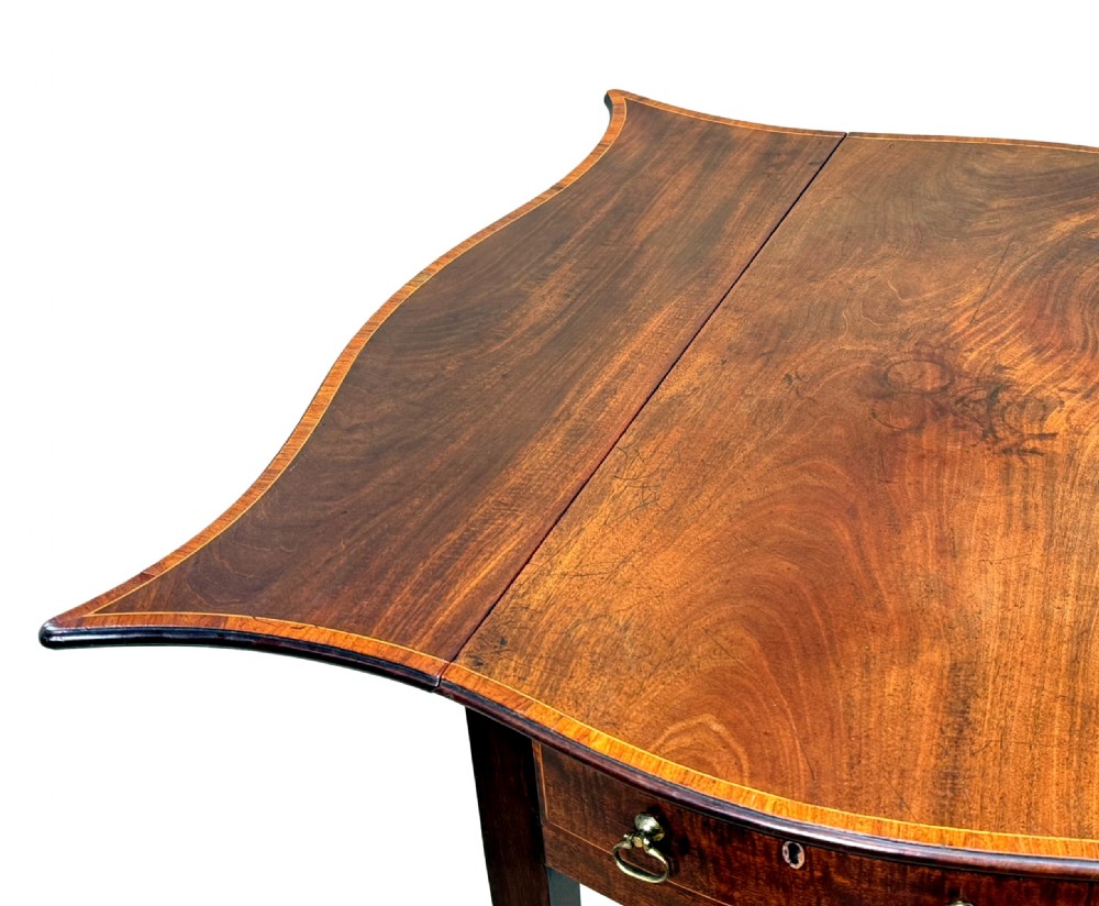 An 18th-century Hepplewhite mahogany Pembroke table with extended shaped drop leaves, a single drawer, and tapered legs on brass castors. View III