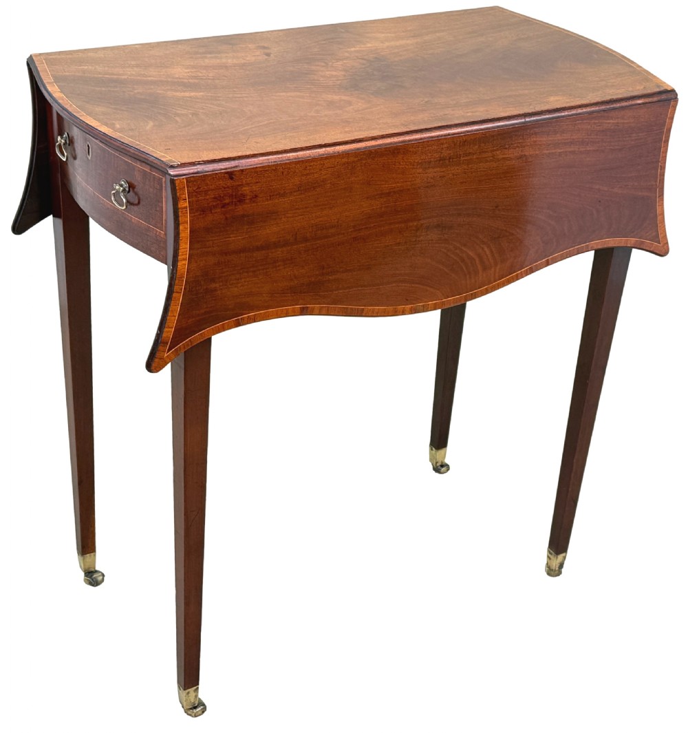An 18th-century Hepplewhite mahogany Pembroke table with extended shaped drop leaves, a single drawer, and tapered legs on brass castors. View IX