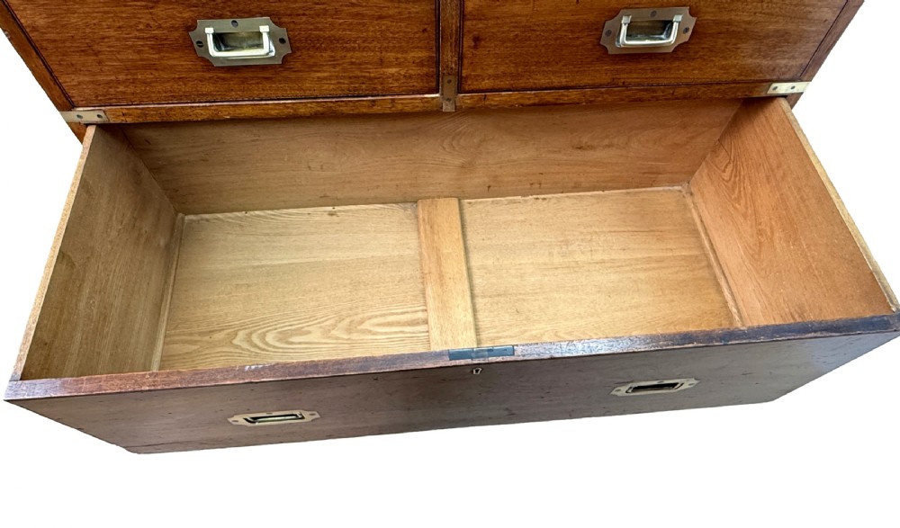 A nineteenth-century camphor wood military campaign chest of drawers featuring flush brass handles, corner brackets, and turned bun feet. View VI