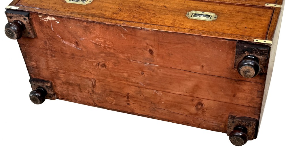 A nineteenth-century camphor wood military campaign chest of drawers featuring flush brass handles, corner brackets, and turned bun feet. View XIII