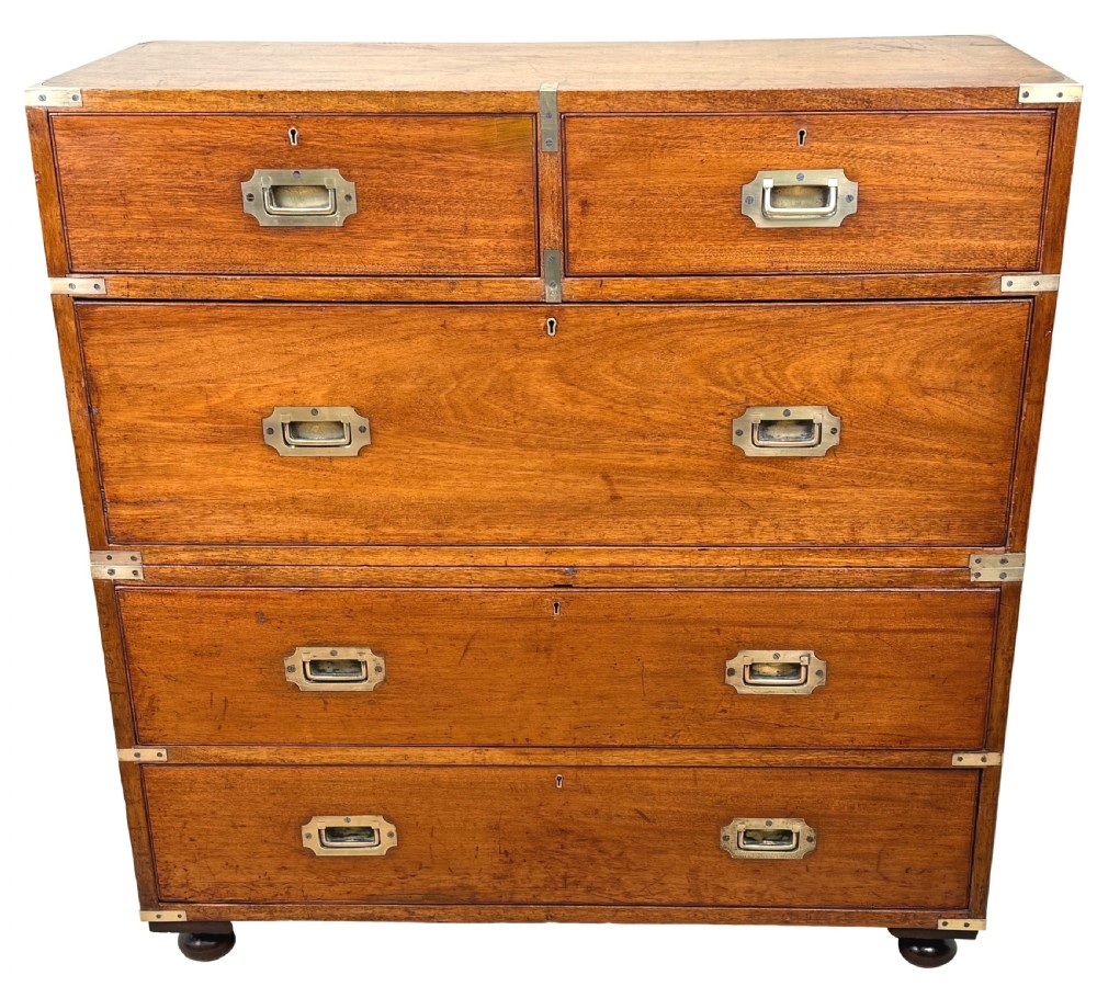 A nineteenth-century camphor wood military campaign chest of drawers featuring flush brass handles, corner brackets, and turned bun feet. View XVI