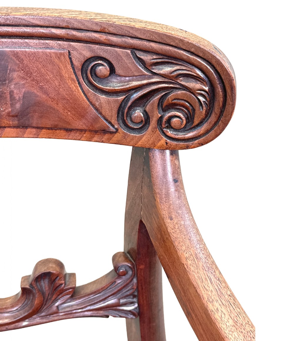 A pair of Regency mahogany carver armchairs featuring scrolled arms, carved back rails, and red plaid upholstered drop-in seats. View VII
