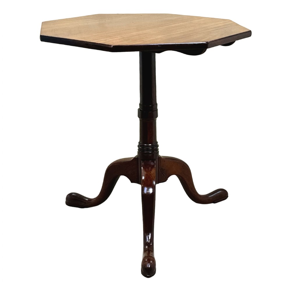 A Georgian mahogany wine table with an octagonal top, turned pedestal stem, and tripod cabriole legs.