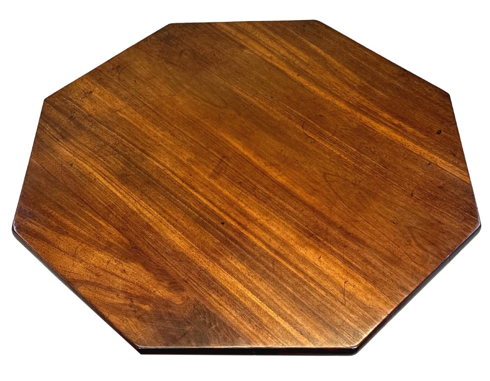 A Georgian mahogany wine table with an octagonal top, turned pedestal stem, and tripod cabriole legs. View VII