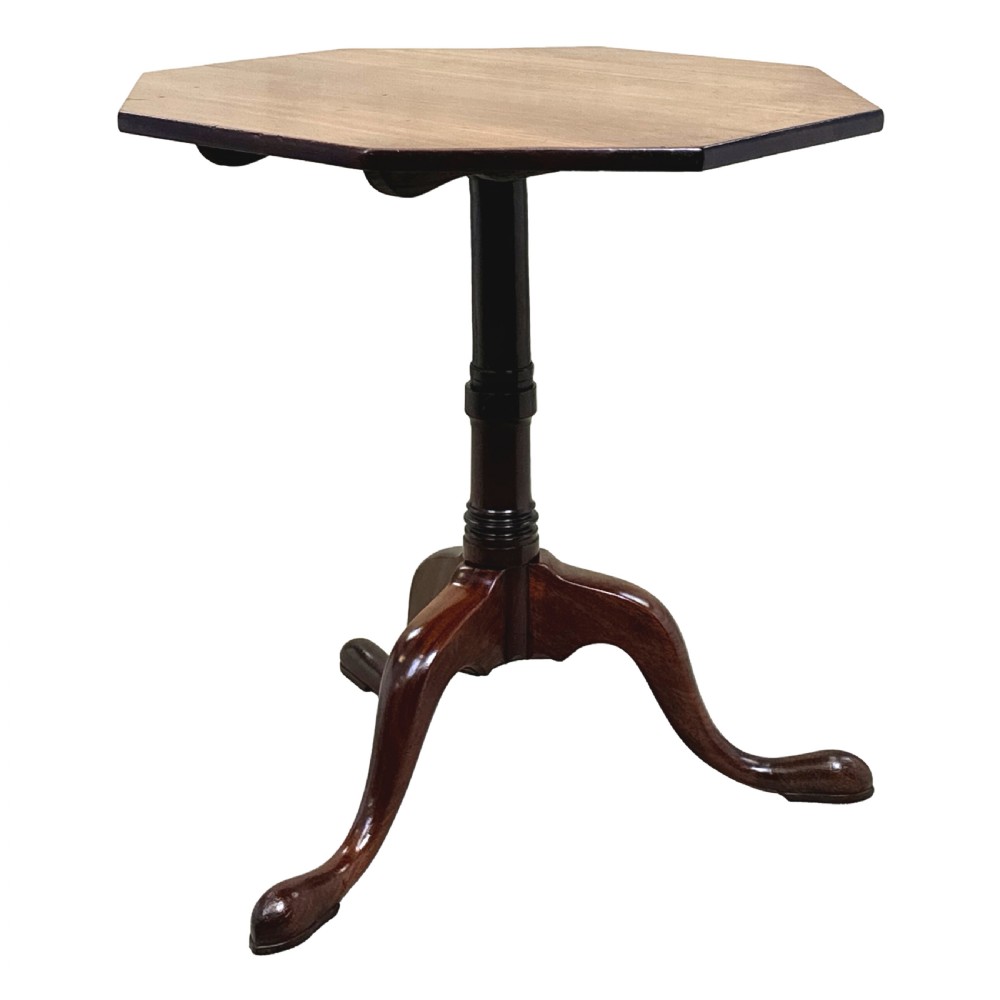 A Georgian mahogany wine table with an octagonal top, turned pedestal stem, and tripod cabriole legs. View X