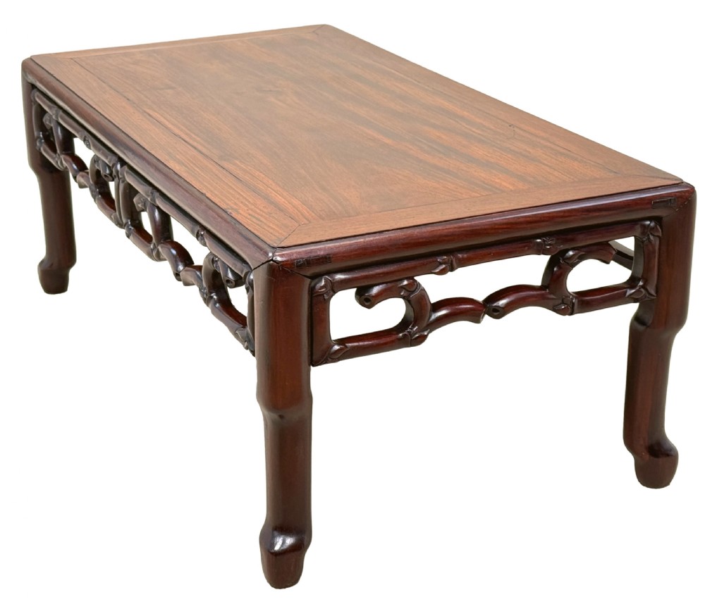 A 19th-century Chinese hardwood coffee table with a rectangular inset top, openwork carved bamboo apron, and low legs. View II