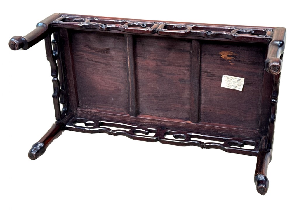 A 19th-century Chinese hardwood coffee table with a rectangular inset top, openwork carved bamboo apron, and low legs. View VIII