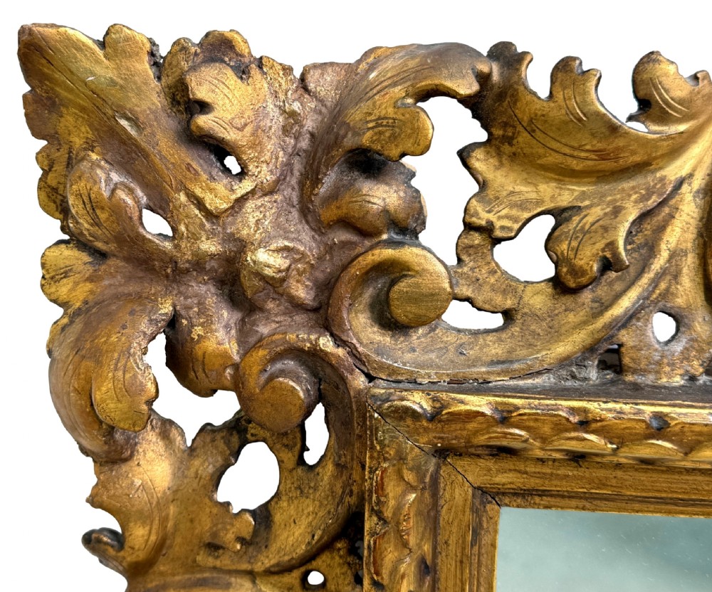 A 19th-century rectangular Italian Florentine mirror framed with deeply carved openwork gilded foliage and acanthus leaf details. View II