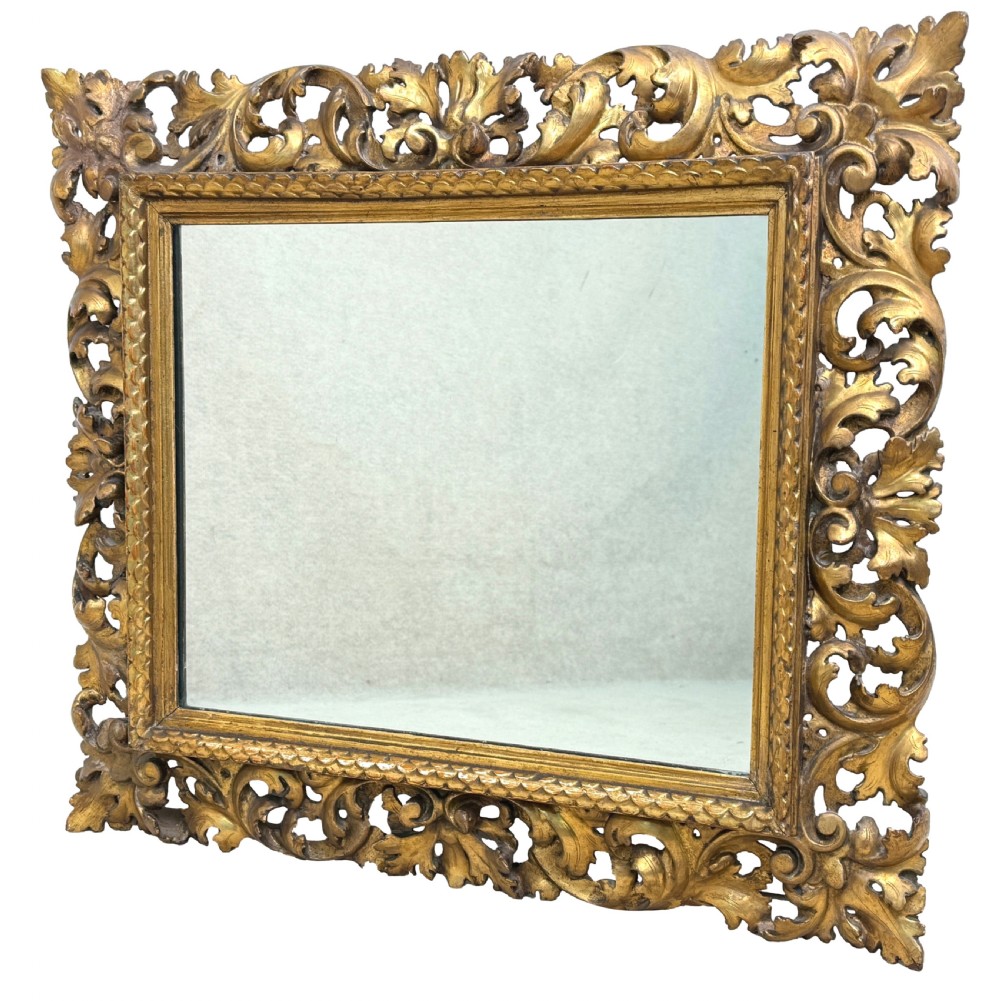 A 19th-century rectangular Italian Florentine mirror framed with deeply carved openwork gilded foliage and acanthus leaf details. View III