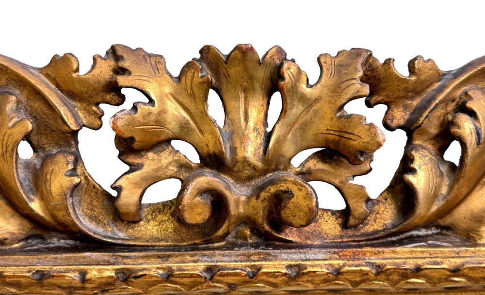 A 19th-century rectangular Italian Florentine mirror framed with deeply carved openwork gilded foliage and acanthus leaf details. View V