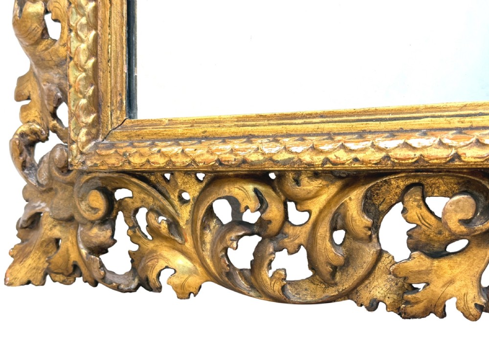 A 19th-century rectangular Italian Florentine mirror framed with deeply carved openwork gilded foliage and acanthus leaf details. View VII