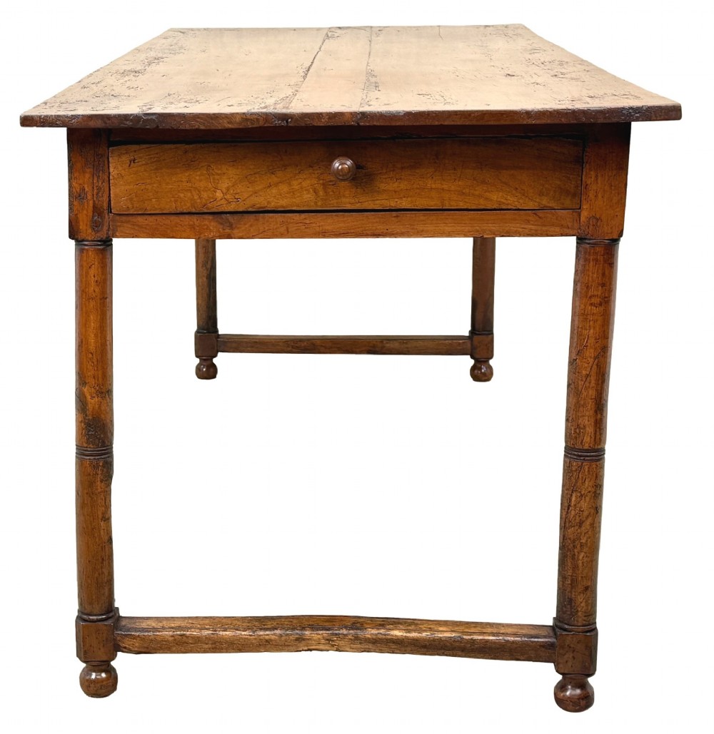 A 19th-century French Provincial fruitwood farmhouse table featuring a rectangular plank top, single end drawer, turned legs, and lower side stretchers. View II