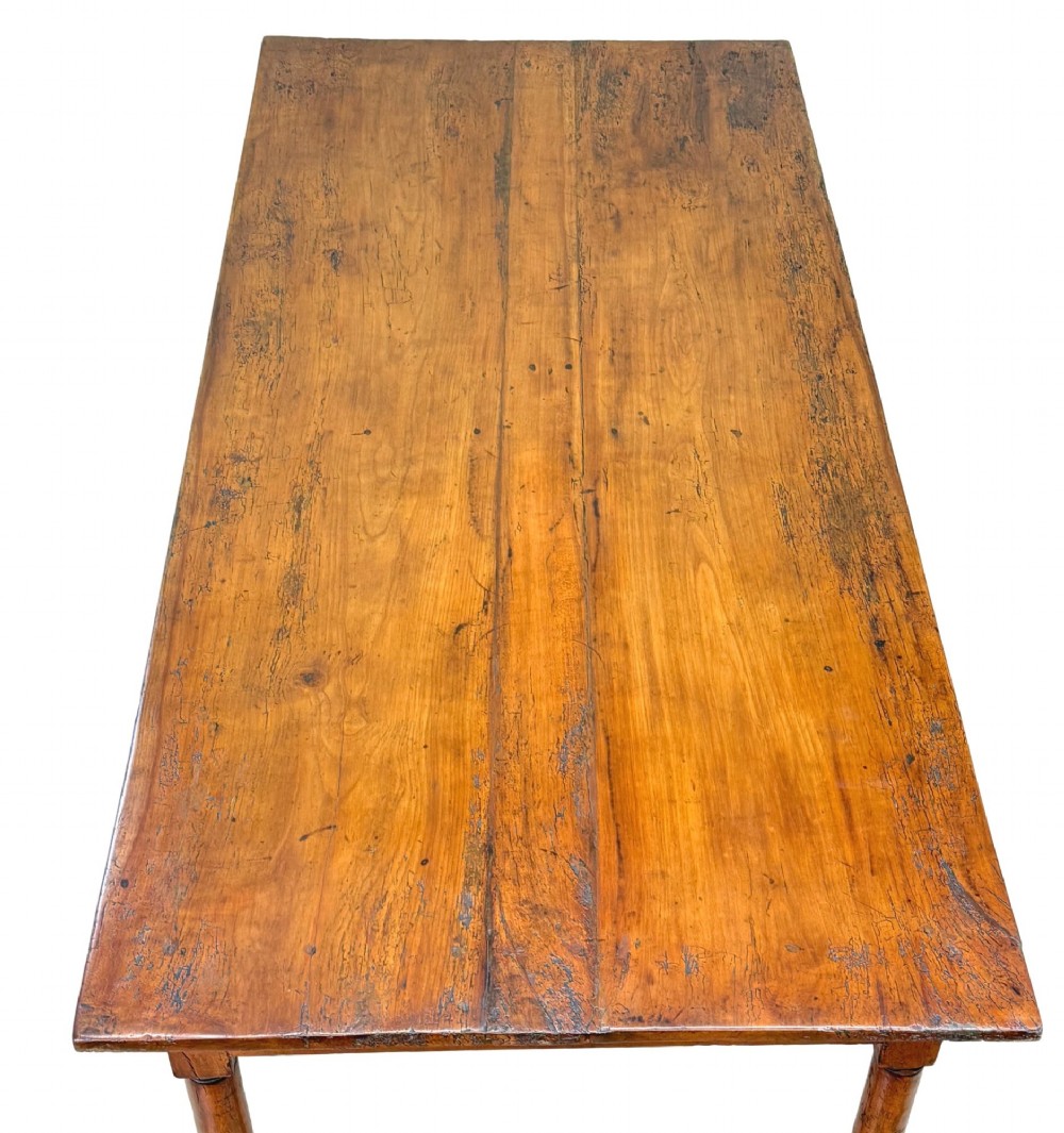 A 19th-century French Provincial fruitwood farmhouse table featuring a rectangular plank top, single end drawer, turned legs, and lower side stretchers. View III