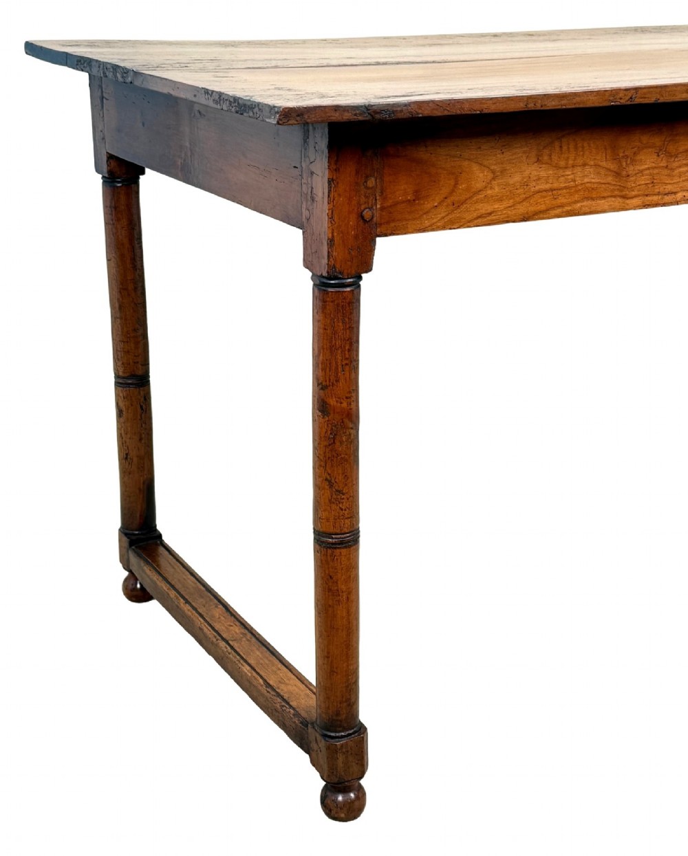 A 19th-century French Provincial fruitwood farmhouse table featuring a rectangular plank top, single end drawer, turned legs, and lower side stretchers. View VI