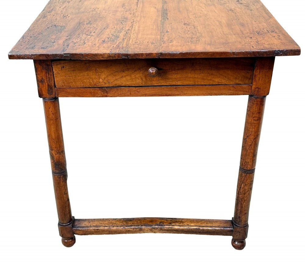 A 19th-century French Provincial fruitwood farmhouse table featuring a rectangular plank top, single end drawer, turned legs, and lower side stretchers. View VIII