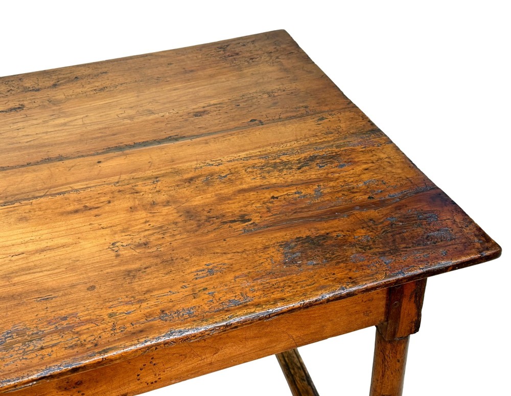 A 19th-century French Provincial fruitwood farmhouse table featuring a rectangular plank top, single end drawer, turned legs, and lower side stretchers. View X