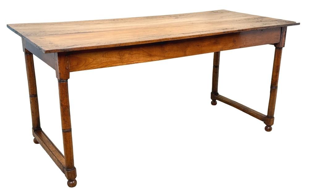 A 19th-century French Provincial fruitwood farmhouse table featuring a rectangular plank top, single end drawer, turned legs, and lower side stretchers. View XII