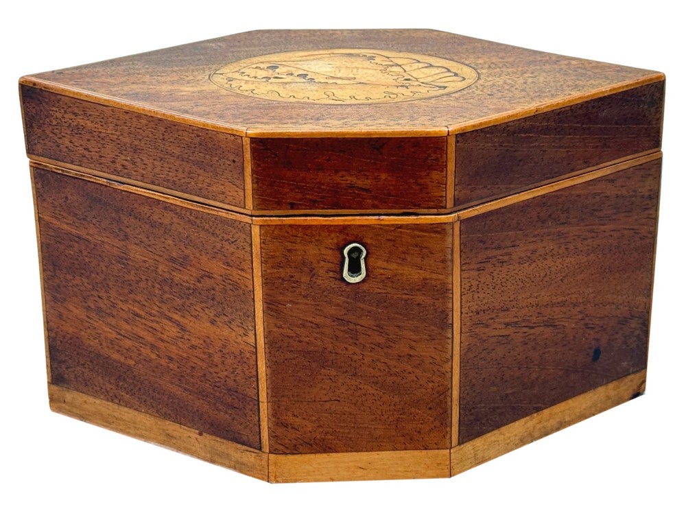 An 18th-century Georgian hexagonal mahogany tea caddy with line inlay and a shell medallion on the lid. View X