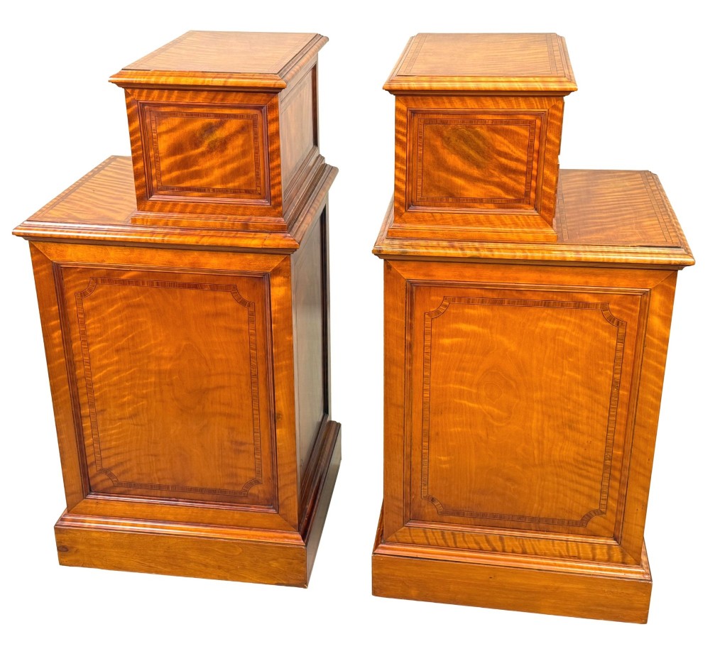 A pair of 19th-century golden satinwood bedside chests featuring stepped top sections with drawers, crossbanded inlay, and brass ring handles. View II