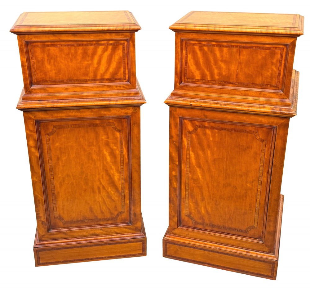 A pair of 19th-century golden satinwood bedside chests featuring stepped top sections with drawers, crossbanded inlay, and brass ring handles. View V