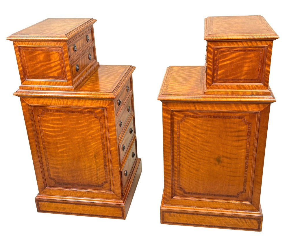 A pair of 19th-century golden satinwood bedside chests featuring stepped top sections with drawers, crossbanded inlay, and brass ring handles. View VI