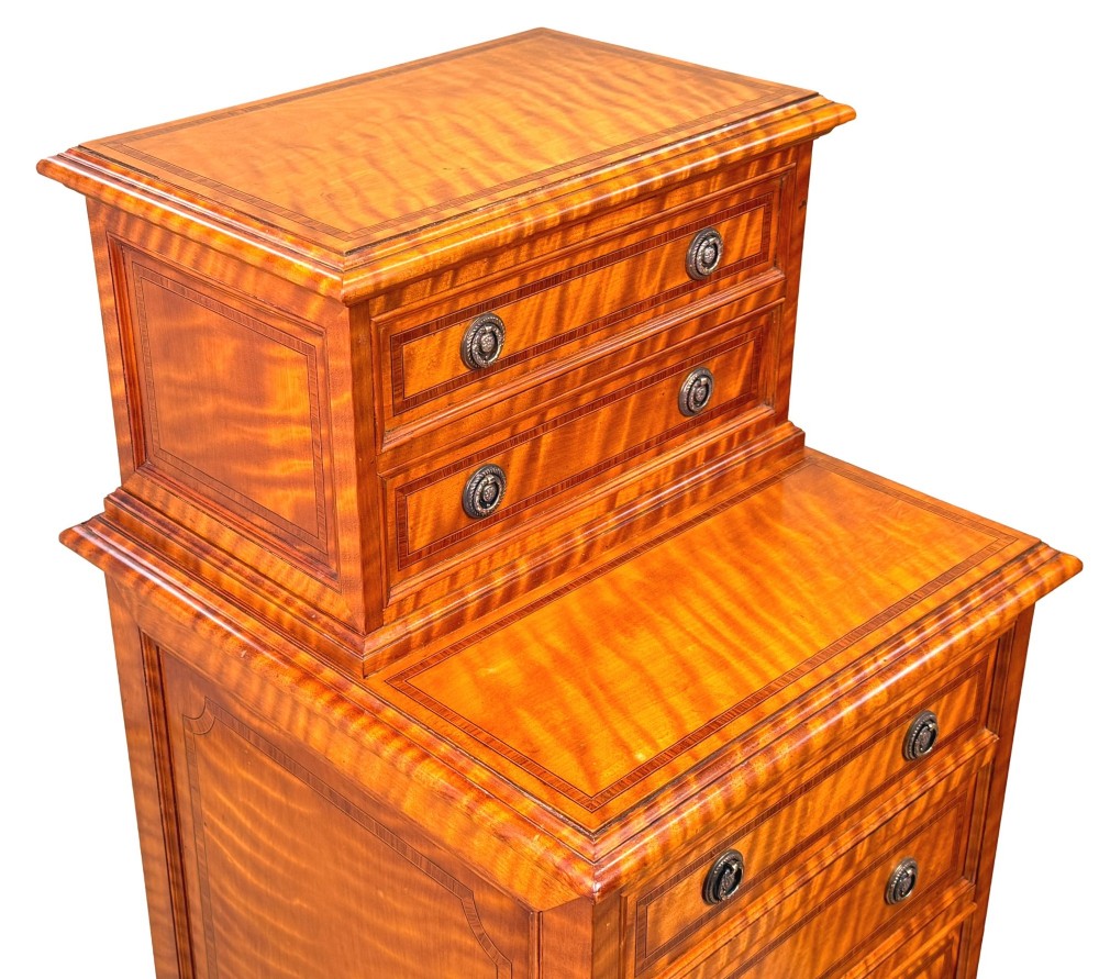A pair of 19th-century golden satinwood bedside chests featuring stepped top sections with drawers, crossbanded inlay, and brass ring handles. View VIII