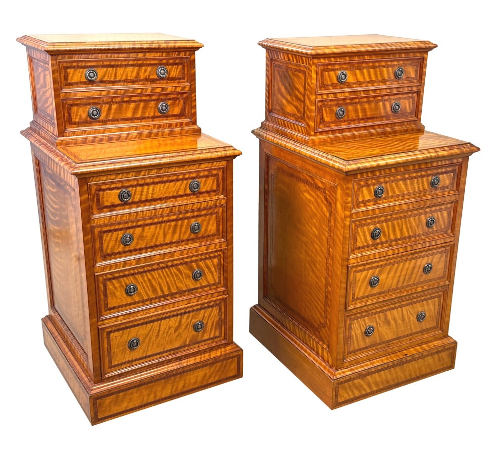 A pair of 19th-century golden satinwood bedside chests featuring stepped top sections with drawers, crossbanded inlay, and brass ring handles. View IX