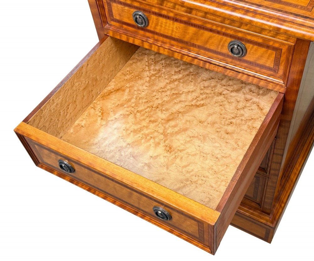 A pair of 19th-century golden satinwood bedside chests featuring stepped top sections with drawers, crossbanded inlay, and brass ring handles. View X