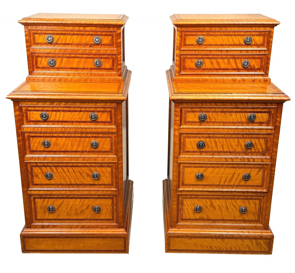 A pair of 19th-century golden satinwood bedside chests featuring stepped top sections with drawers, crossbanded inlay, and brass ring handles. View XII